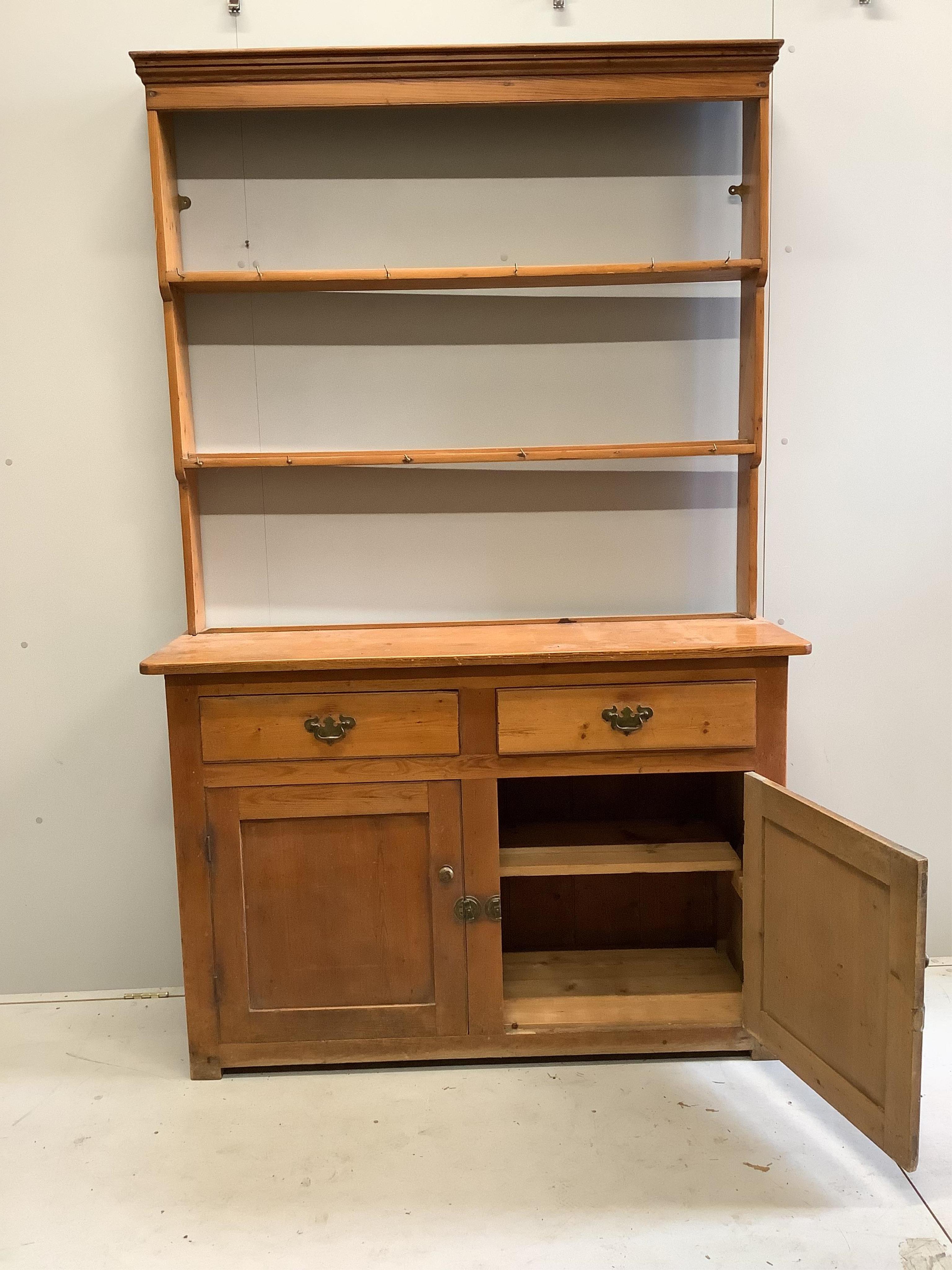 A Victorian pine dresser with open rack, width 137cm, depth 47cm, height 216cm. Condition - fair